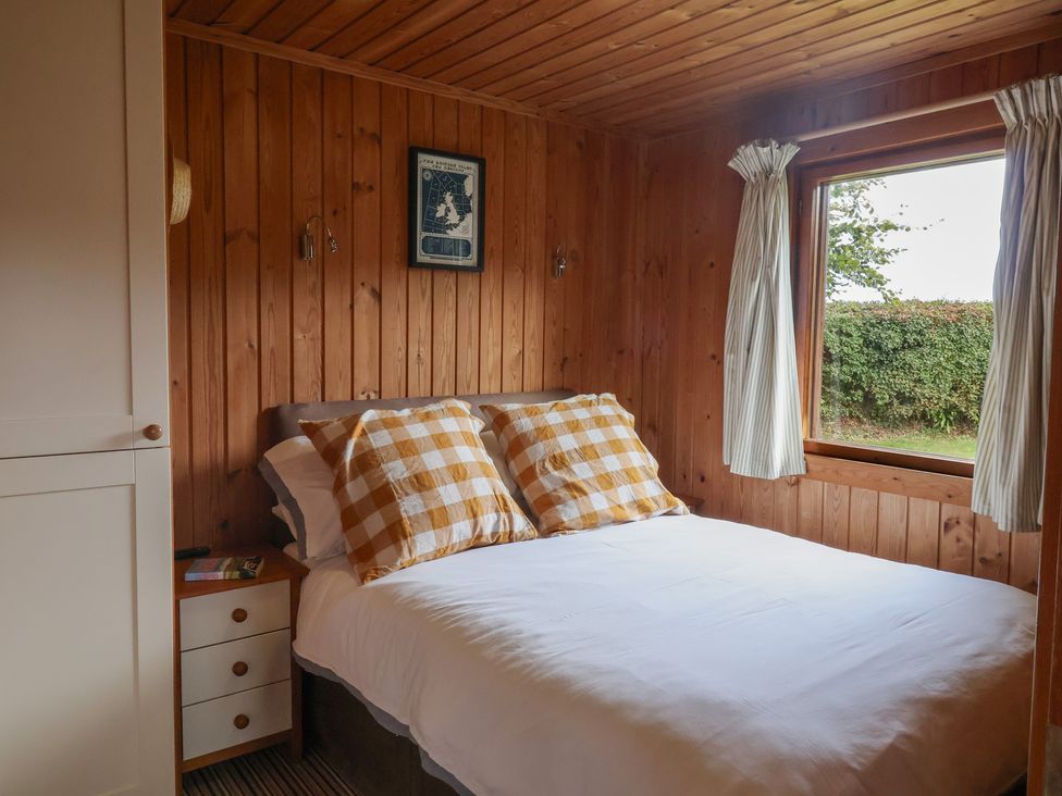 A bedroom with a bed and a window at 10 Pinewood Retreat in Pinewood
