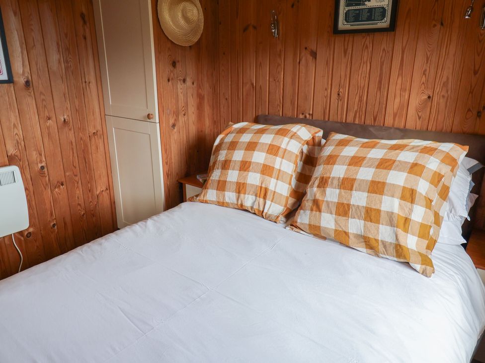 A bedroom with a bed and checked pillows at 10 Pinewood Retreat in Pinewood
