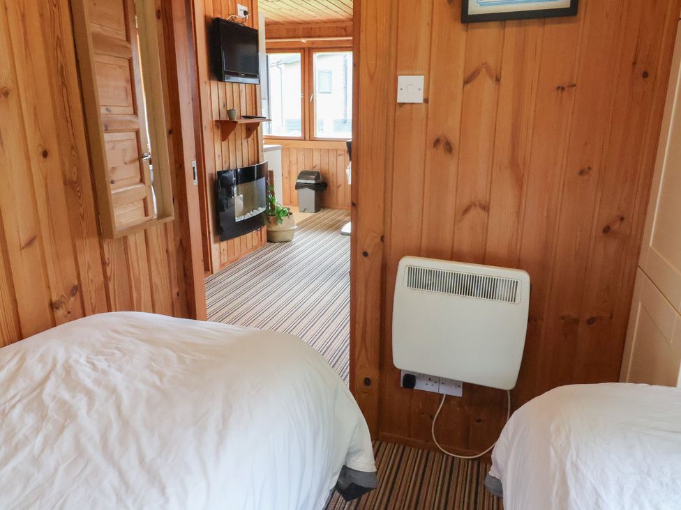 A bedroom with two beds and a television at 10 Pinewood Retreat in Pinewood