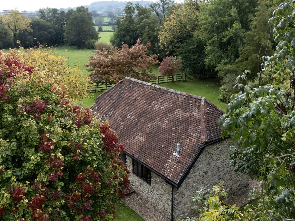 A building surrounded by trees and grass at The Cider House in Dalwood