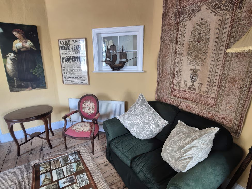 A living room with a sofa and table at Old Monmouth Lyme Regis