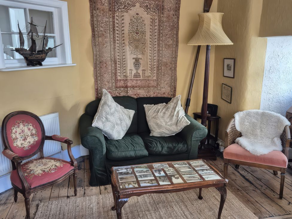 A living room with a sofa and coffee table at Old Monmouth in Lyme Regis