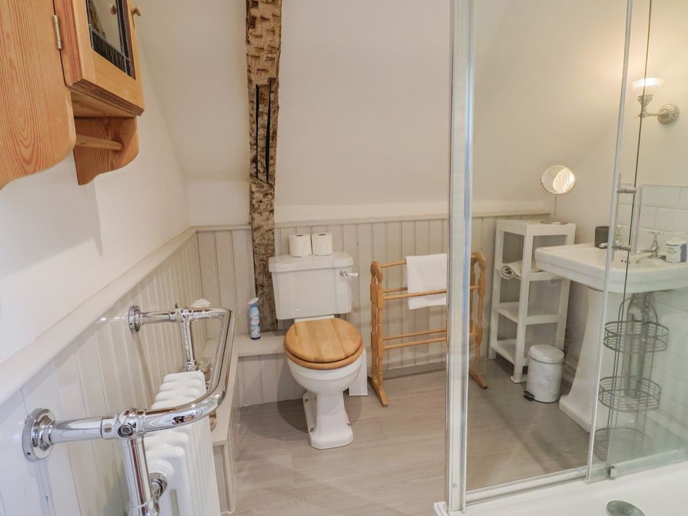A bathroom with a toilet and sink at The Little Rose in Lyme Regis