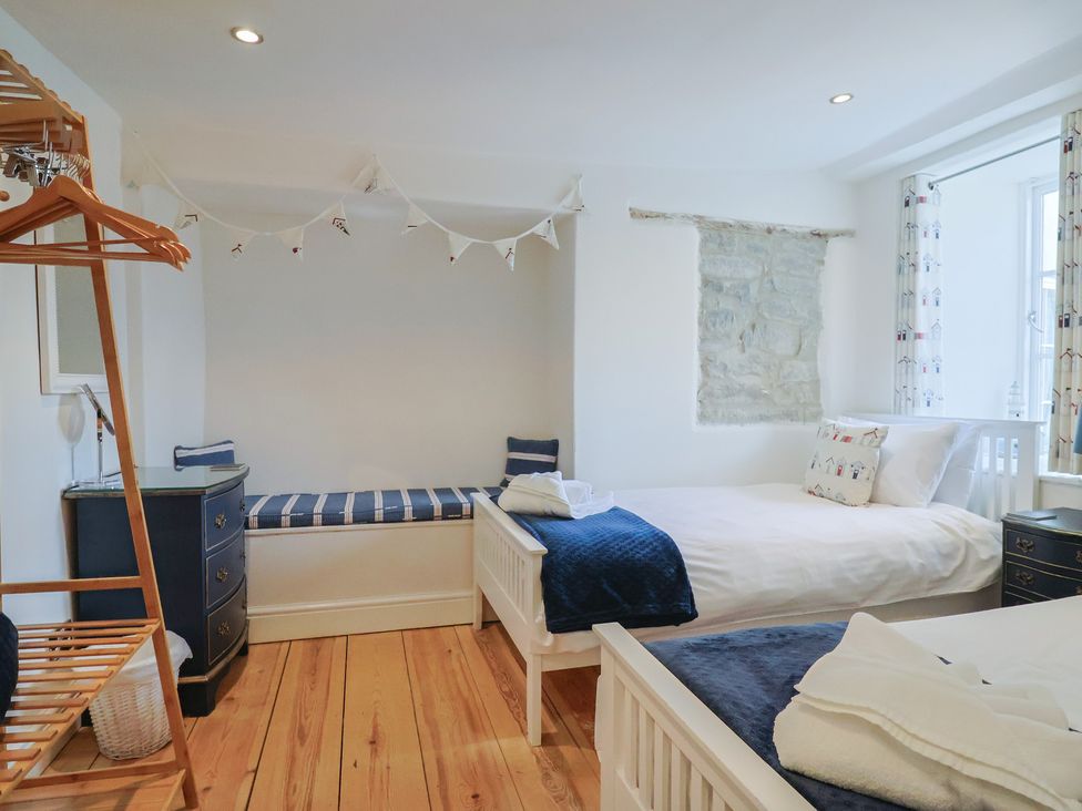 A bedroom with two beds and a window at The Little Rose in Lyme Regis