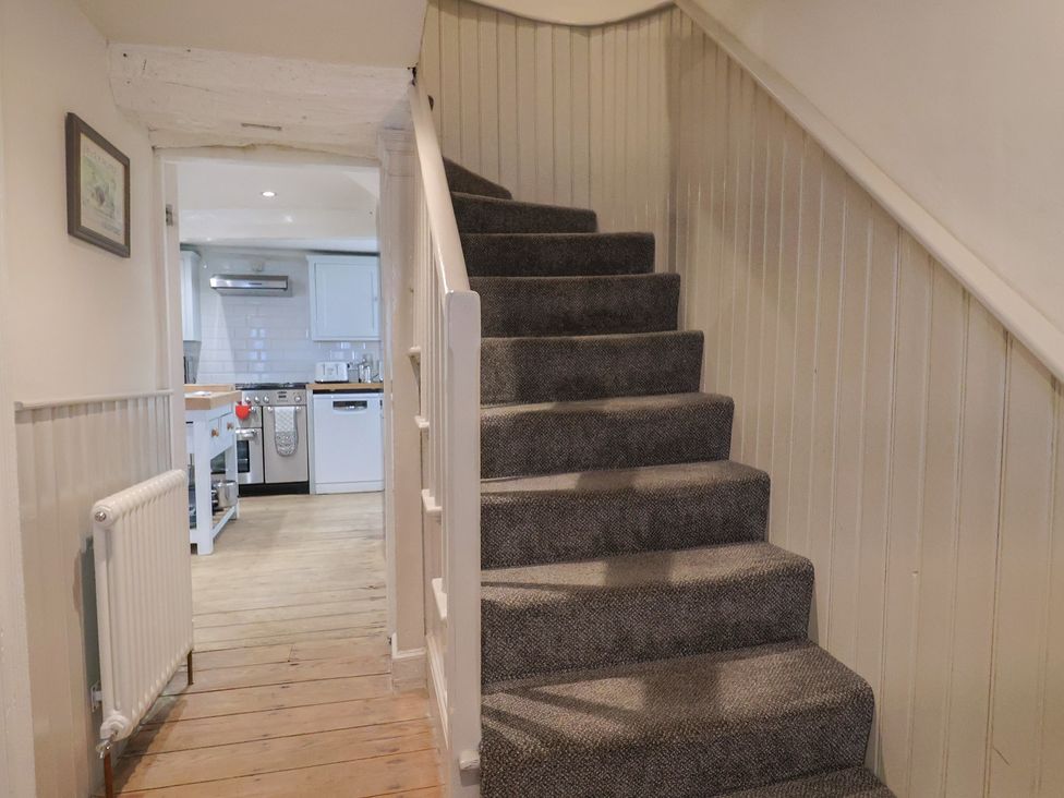 A staircase leading to an upper level at The Little Rose in Lyme Regis