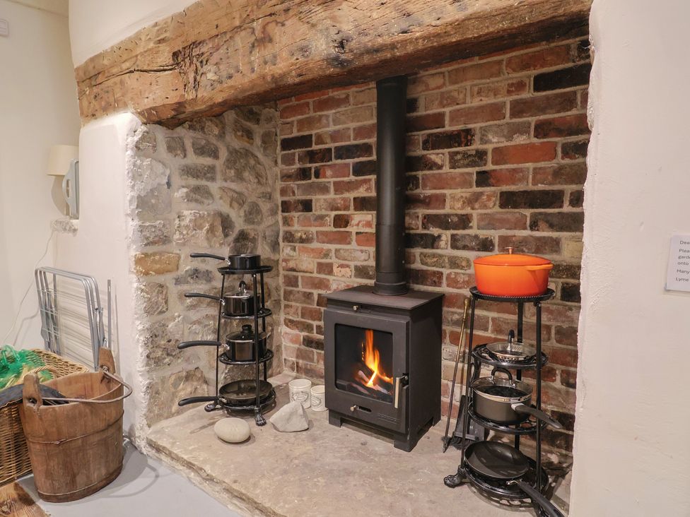 A kitchen with a stove and cooking equipment at The Little Rose in Lyme Regis
