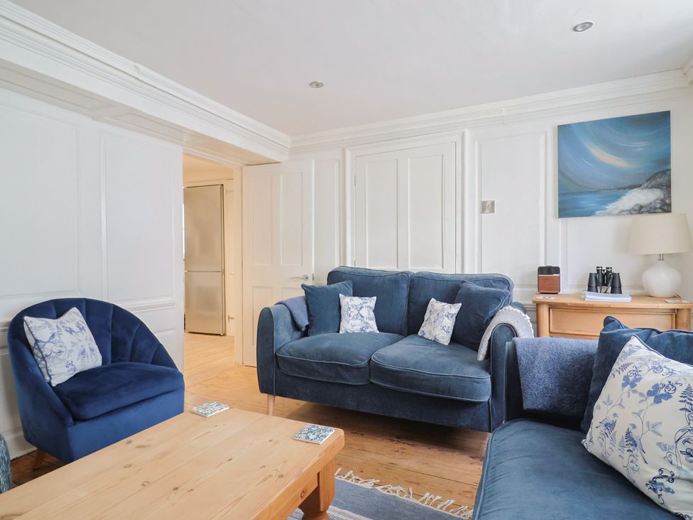 A living room with sofa and armchair at The Little Rose in Lyme Regis