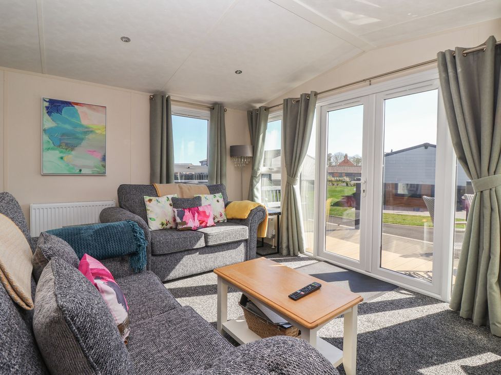 A living room with a sofa and coffee table at Away Daze in Carnaby near Bridlington