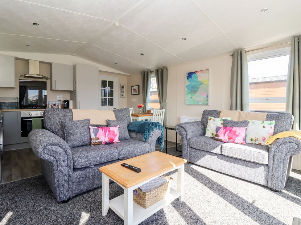 A living room with a sofa and dining table at Away Daze in Carnaby near Bridlington