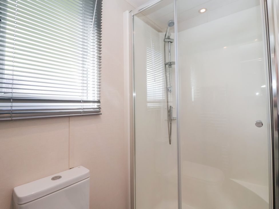 A bathroom with a shower and a toilet at Away Daze in Carnaby near Bridlington