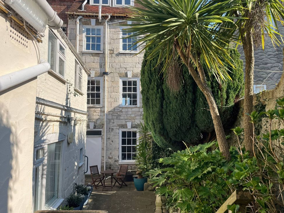 An outdoor area with a table and chairs at Embassy in Brewers Quay Harbour
