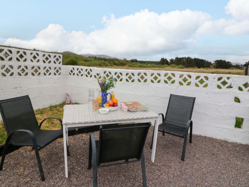 A patio area with table and chairs outside at Forest View Ballinskelligs, County Kerry