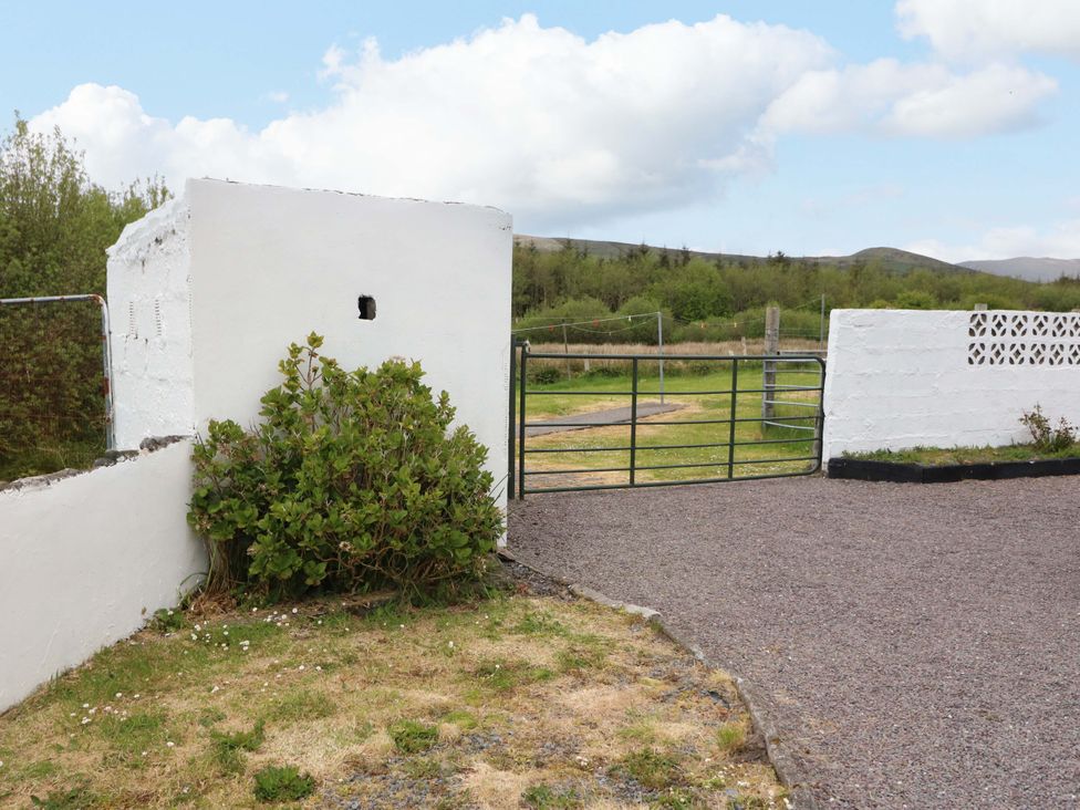 An outdoor area with a gate and white wall at Forest View, Ballinskelligs, County Kerry