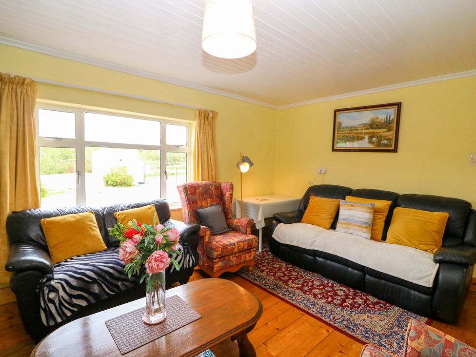 A living room with a sofa and armchair at Forest View in Ballinskelligs, County Kerry