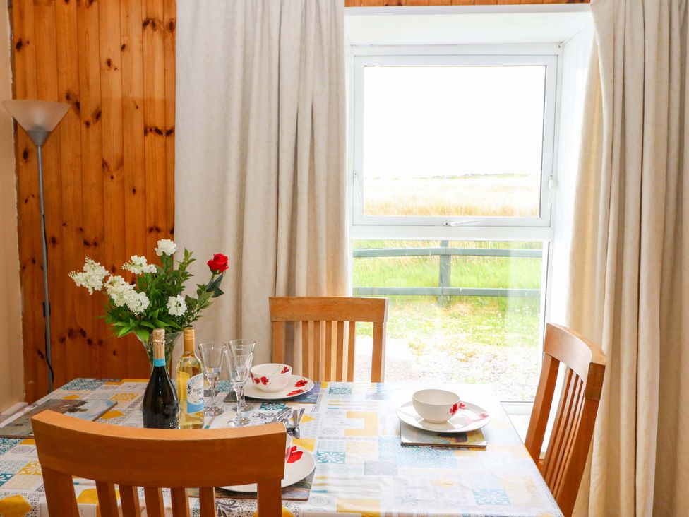 A dining room with a table set for lunch at Forest View in Ballinskelligs, County Kerry