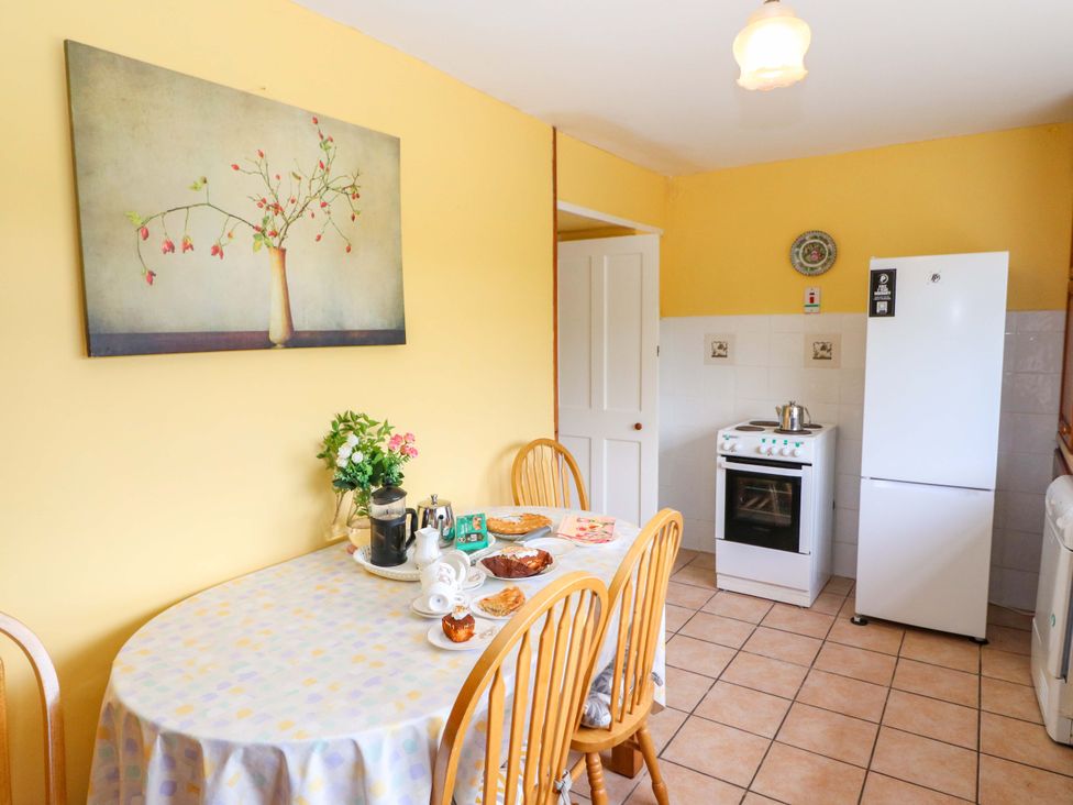 A kitchen with a table and chairs at Forest View in Ballinskelligs, County Kerry