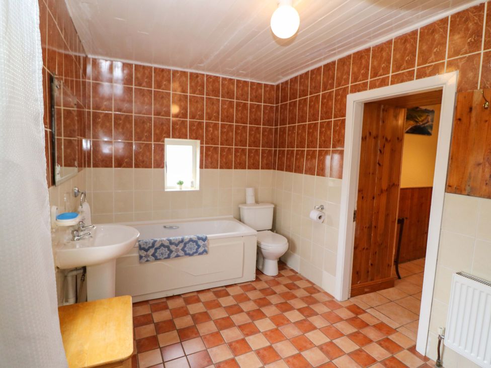 A bathroom with a bath tub and sink at Forest View in Ballinskelligs, County Kerry