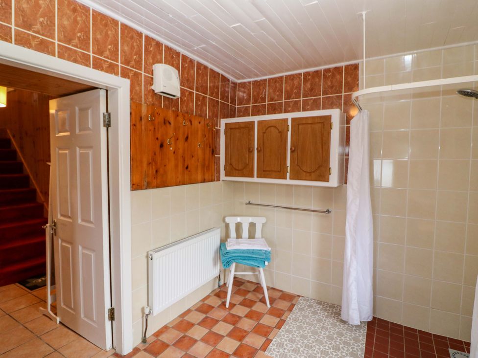 A bathroom with a shower and storage cabinets at Forest View in Ballinskelligs, County Kerry