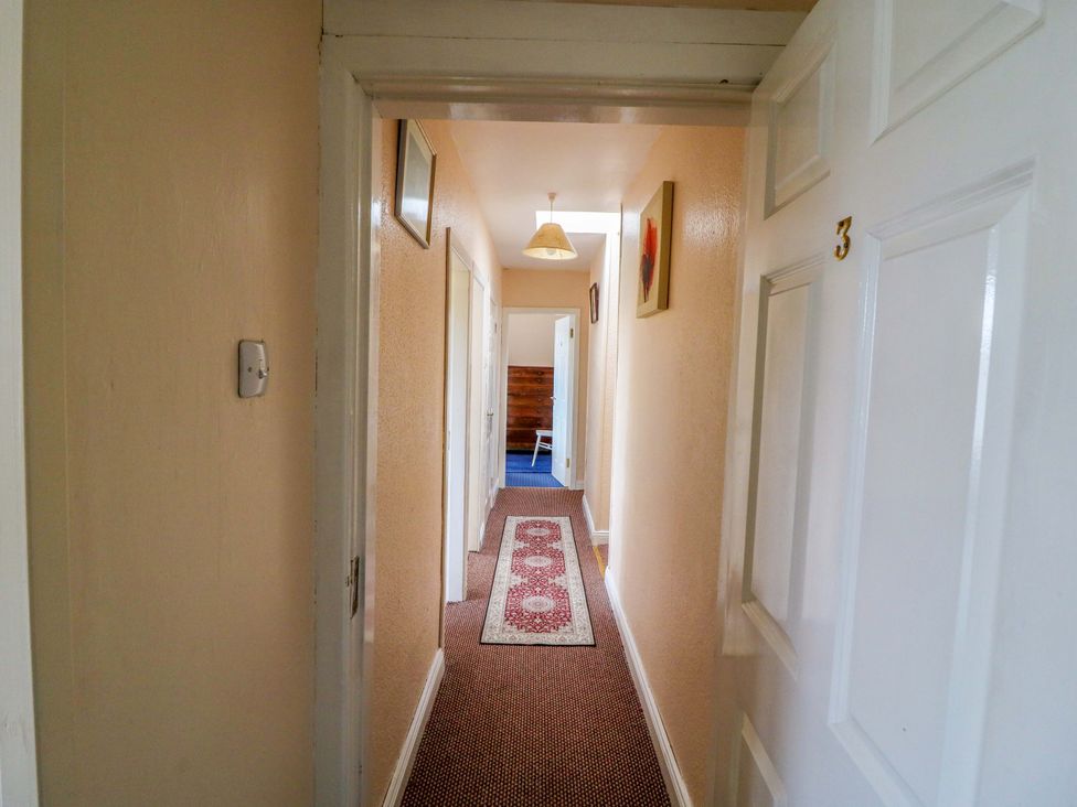A hallway with doors and a carpet at Forest View in Ballinskelligs, County Kerry