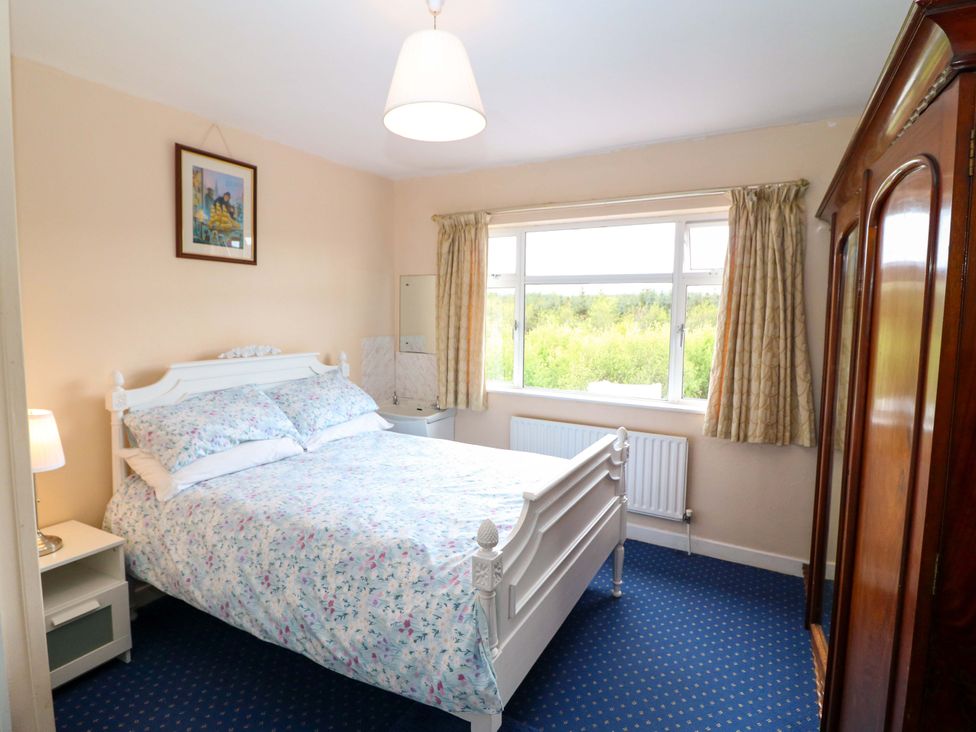 A bedroom with a bed and window at Forest View in Ballinskelligs, County Kerry