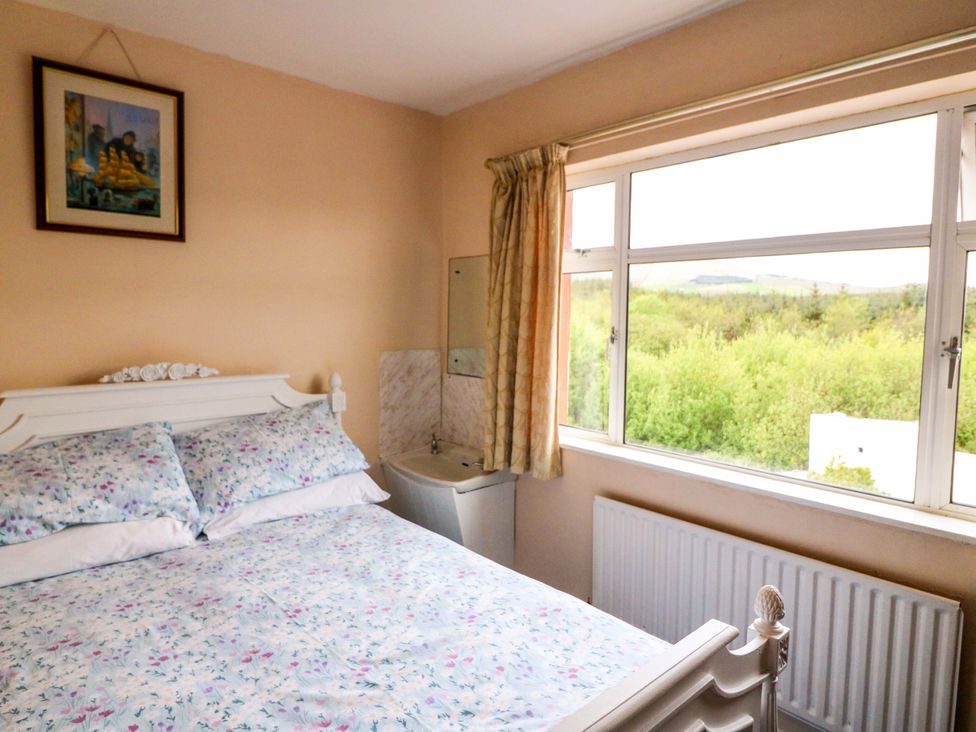 A bedroom with a bed and window at Forest View in Ballinskelligs, County Kerry
