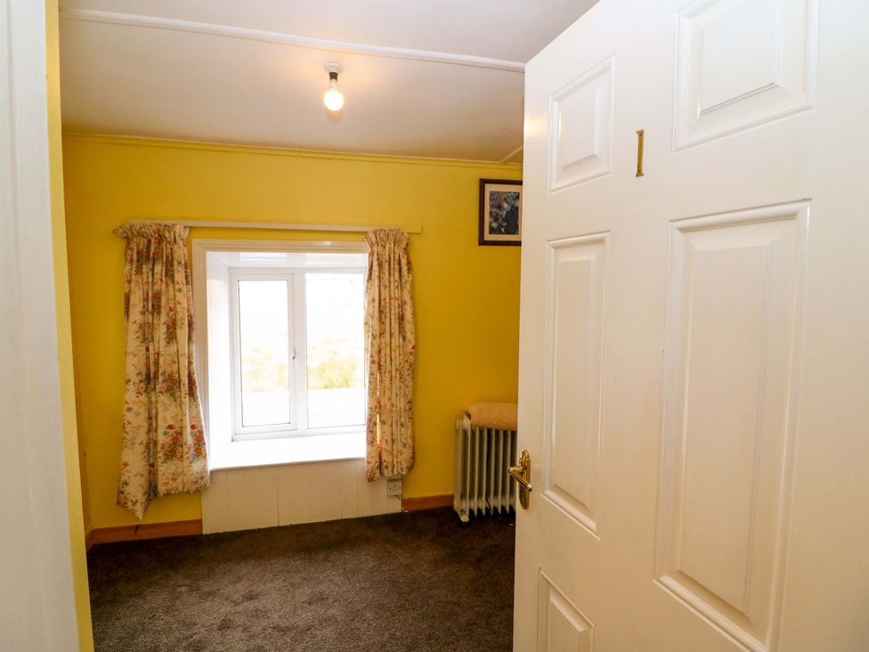 A bedroom with a window and radiator at Forest View in Ballinskelligs, County Kerry