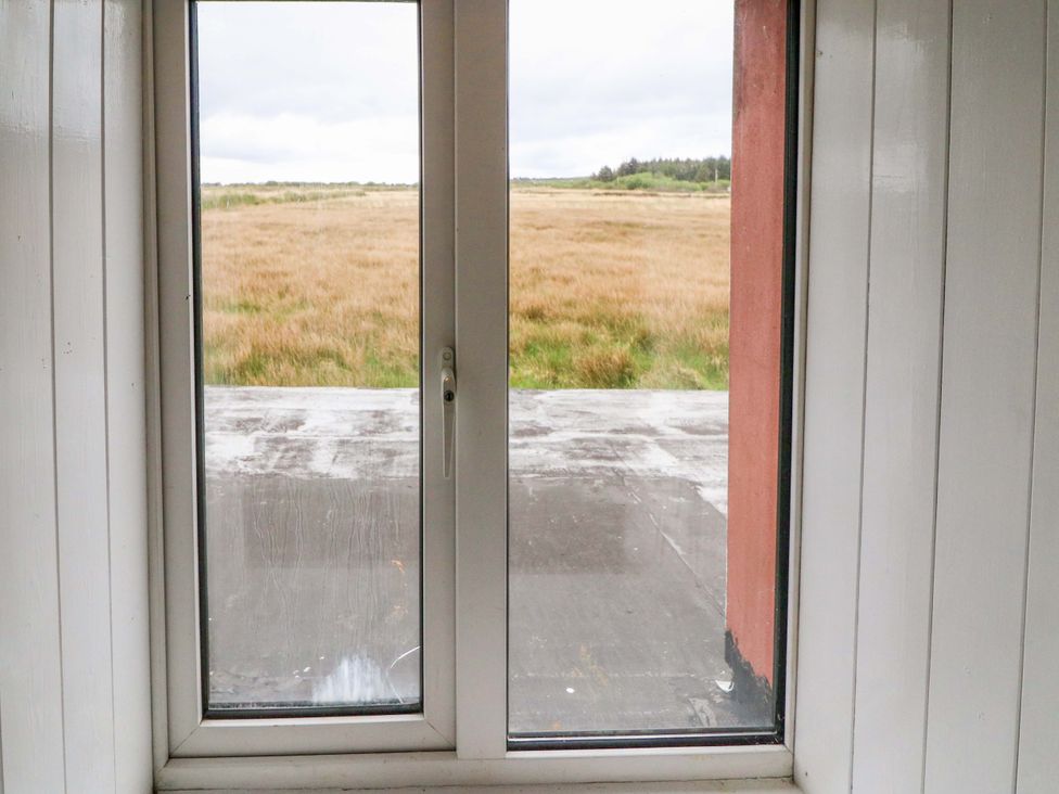 A view from a window showing grassland at Forest View, Ballinskelligs, County Kerry
