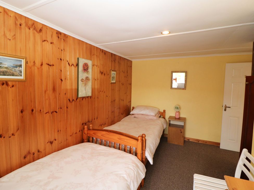 A bedroom with two beds and decor at Forest View in Ballinskelligs, County Kerry