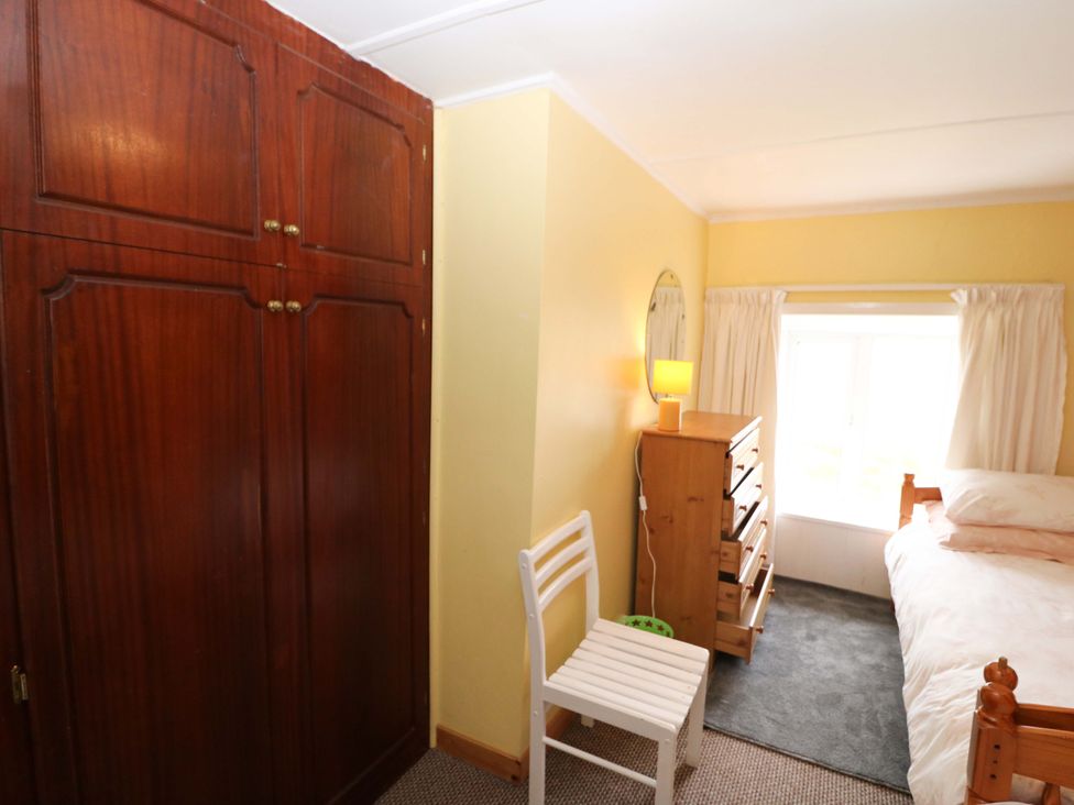 A bedroom with a bed and furniture at Forest View in Ballinskelligs, County Kerry