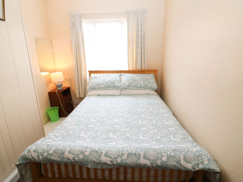 A bedroom with a bed and lamp at Forest View, Ballinskelligs, County Kerry