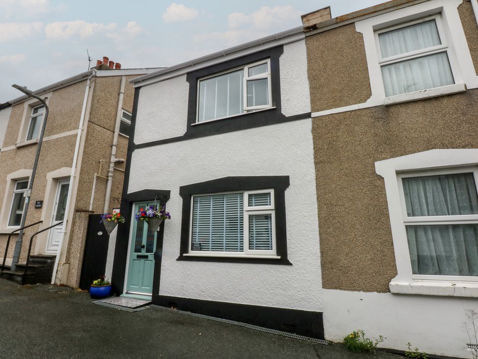 A house with a blue front door and flower pots at 4 Haven Villas in Conwy