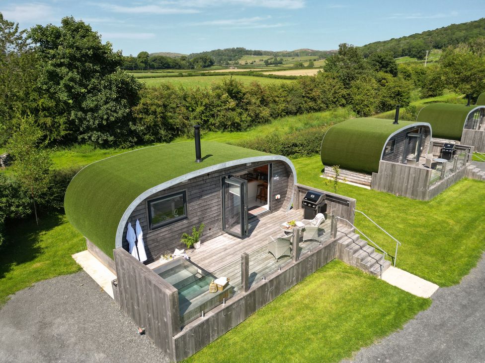 Cabins with grass roofs and outdoor seating area at Low Longlands in Cartmel