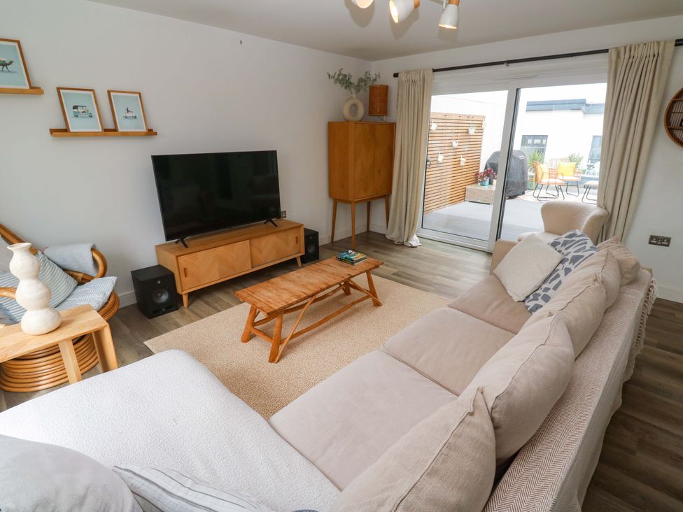 A living room with a television and coffee table at 6 Chapel Rock Close in Perranporth