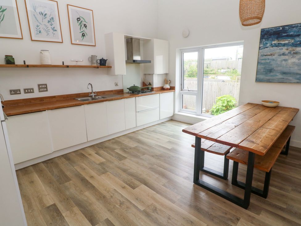 A kitchen with a dining table and chairs at 6 Chapel Rock Close Perranporth