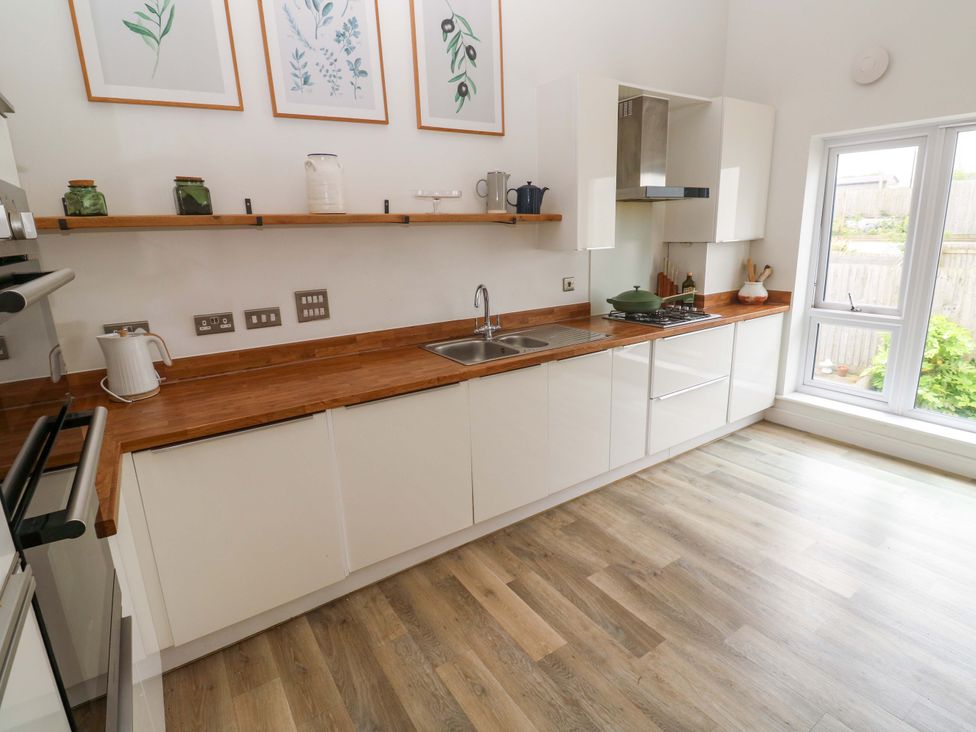 A kitchen with a sink, oven, and countertop at 6 Chapel Rock Close in Perranporth