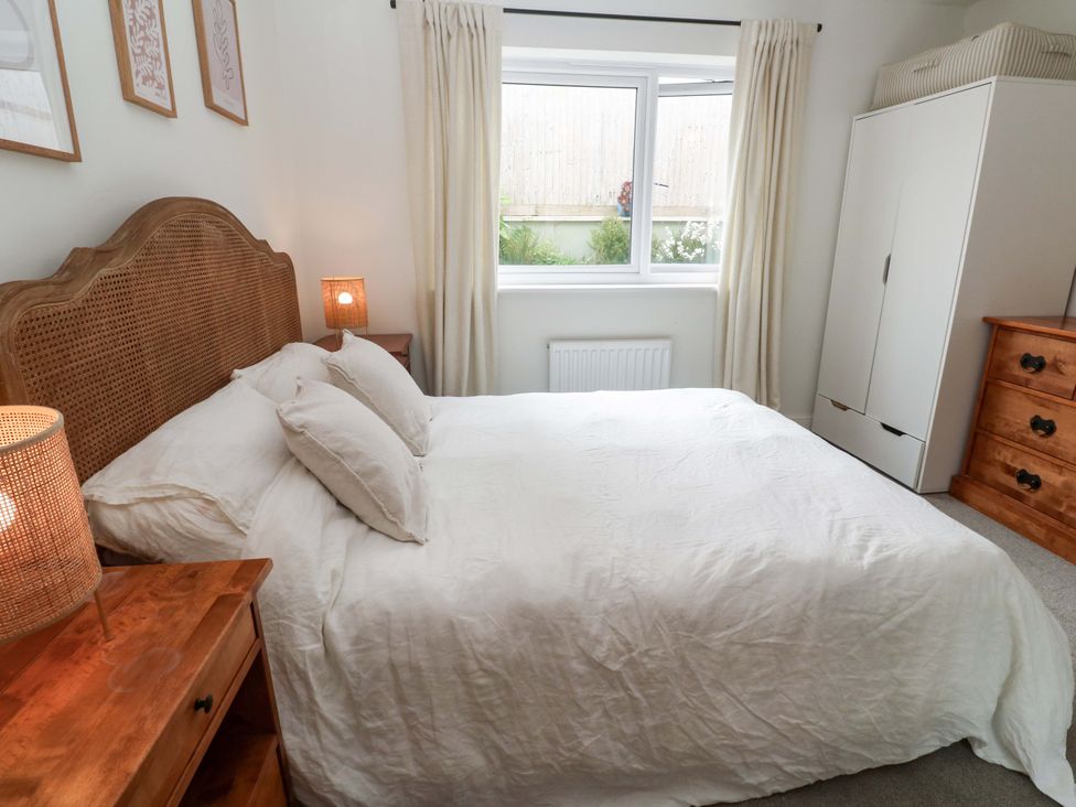 A bedroom with a bed and wardrobe at 6 Chapel Rock Close Perranporth