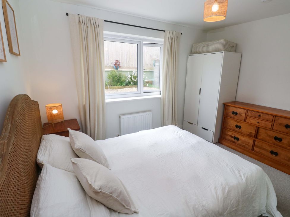 A bedroom with a bed and lamps at 6 Chapel Rock Close Perranporth