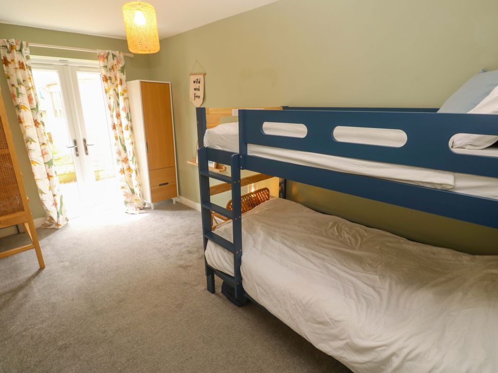 A bedroom with a bunk bed and wardrobe at 6 Chapel Rock Close Perranporth