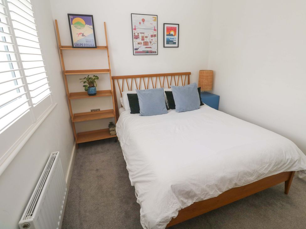 A bedroom with a bed and bookshelf at 6 Chapel Rock Close Perranporth
