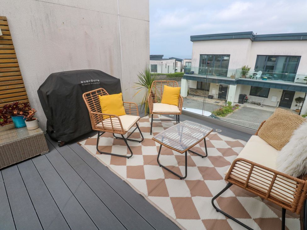 A balcony with seating and a table at 6 Chapel Rock Close Perranporth