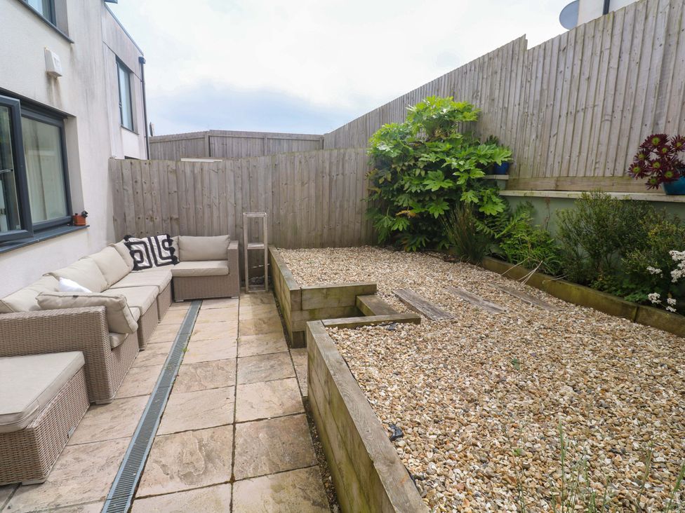 A garden with a sofa and plants at 6 Chapel Rock Close Perranporth