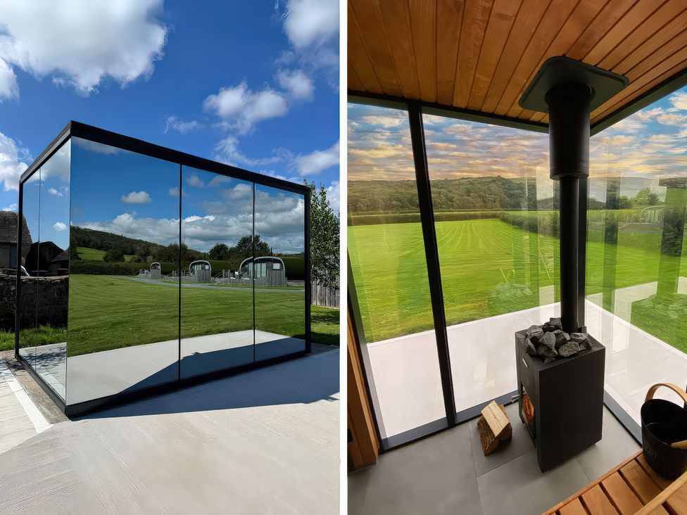 A modern outdoor area with glass walls and a stove at High Longlands in Cartmel
