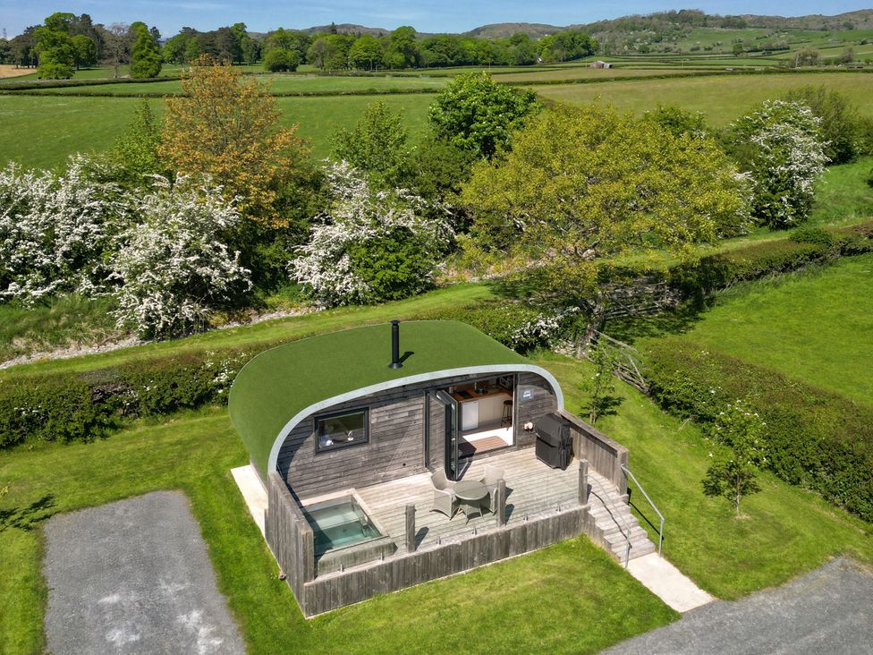 A garden with a modern shed and outdoor seating area at Little Heaning in Cartmel