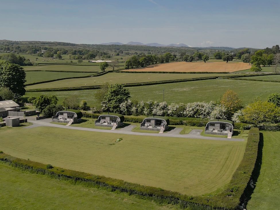 A view of huts in a green field at Little Heaning in Cartmel