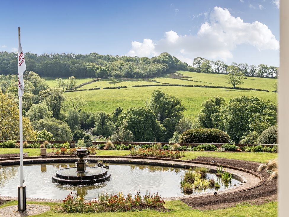 A garden with a fountain and hills at Harcombe House Accessible Pet Free Bungalow Sleeps 5 Chudleigh