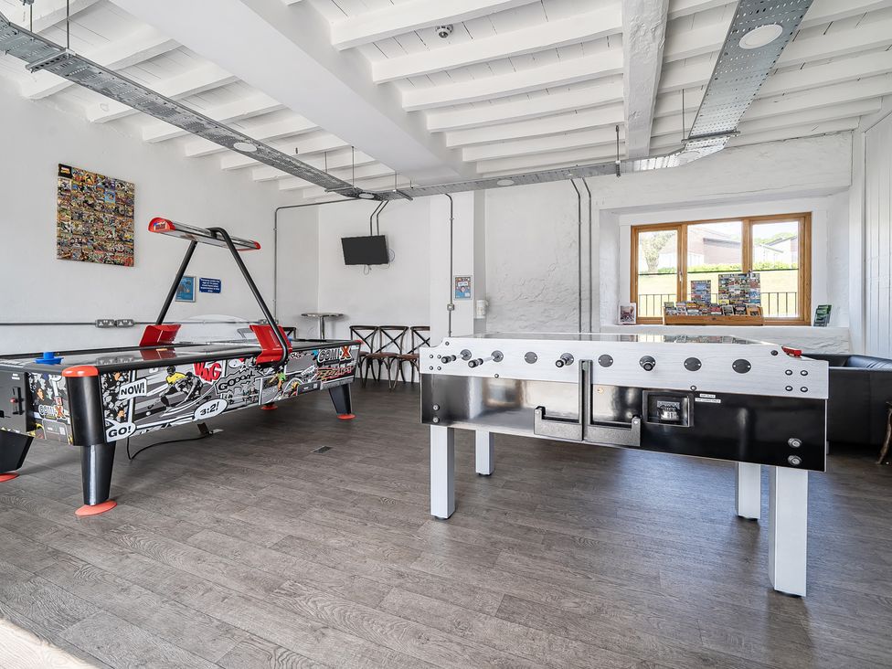 A game room with air hockey and foosball tables at Harcombe House Accessible Pet Free Bungalow Sleeps 5, Chudleigh