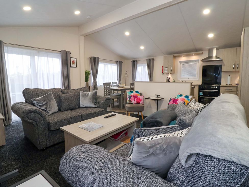 A living room with a sofa and coffee table at Brighter Daze in Carnaby near Bridlington