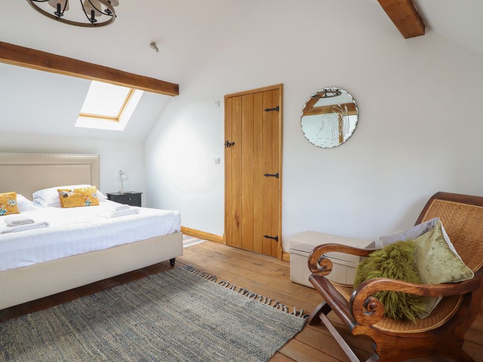 A bedroom with a bed and a nightstand at Cwmwr Penybonfawr