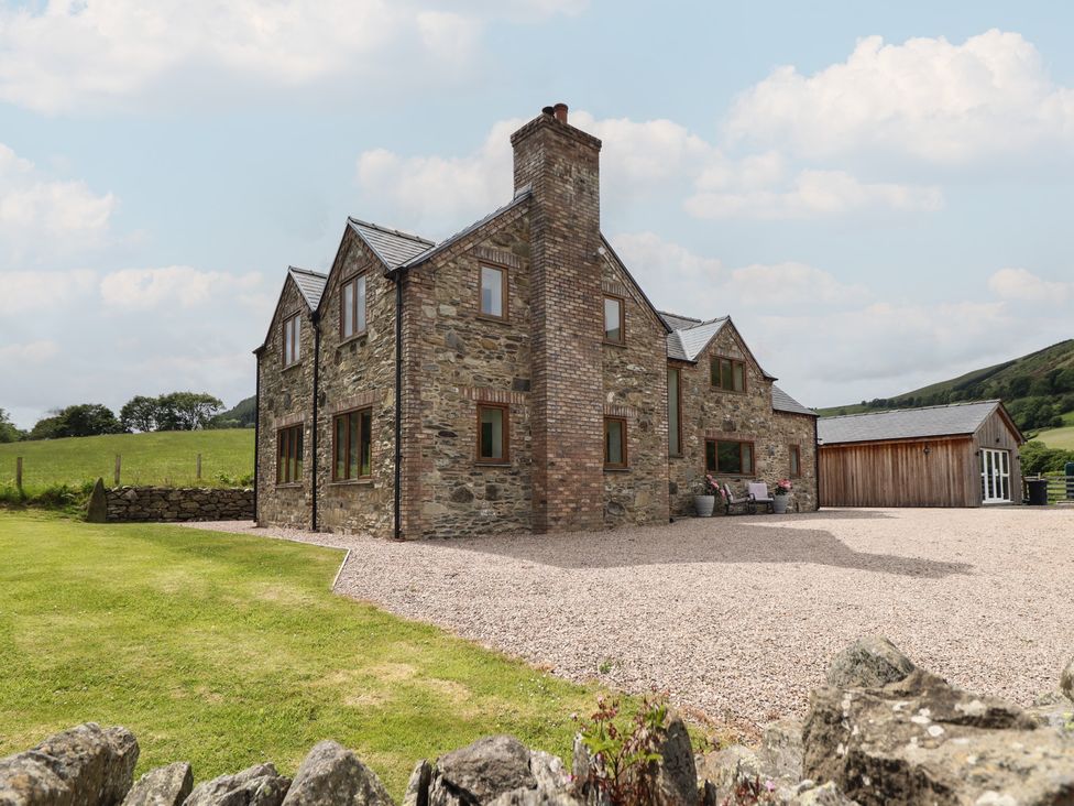 A house with windows and a chimney in a field at Cwmwr Penybontfawr
