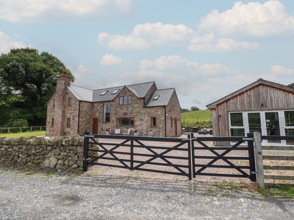 A house with a shed and a gate at Cwmwr Penybontfawr